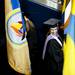 A flag holder waits for the graduation ceremony to start on Sunday. Daniel Brenner I AnnArbor.com